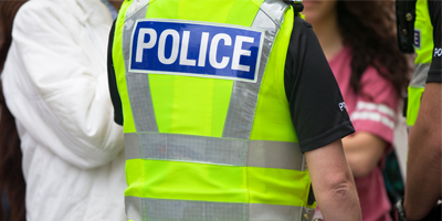 an image of a group of people and a couple of police officers